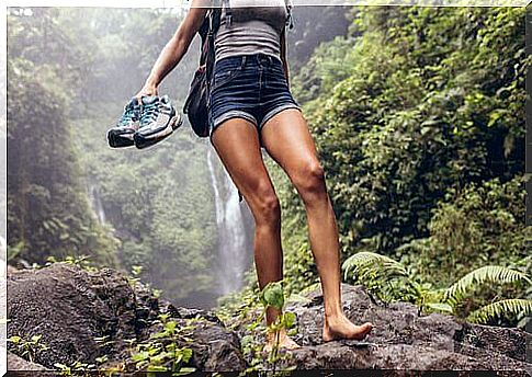 Woman walking barefoot in nature.