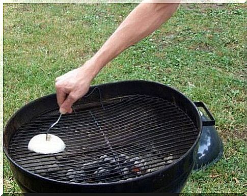 person cleaning barbecue