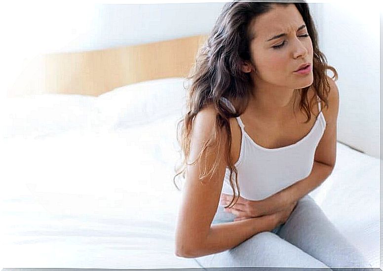 Woman with stomach ache because she has stomach ulcers